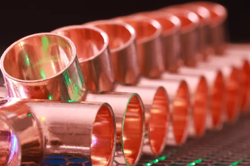 A row of new copper pipe fittings