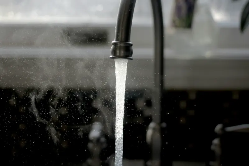 Hot water running from a kitchen mixer tap